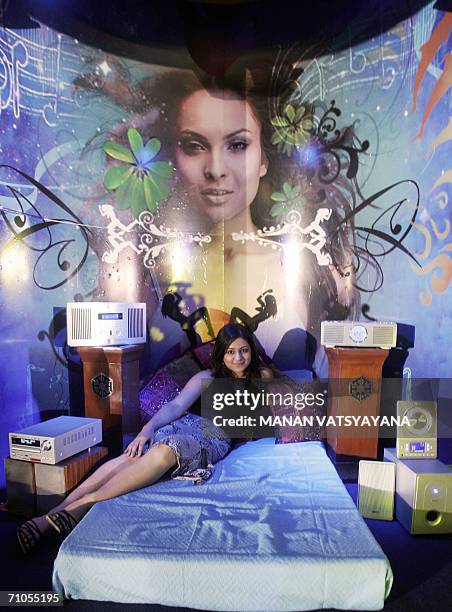 An Indian model poses with the newly unveiled range of TEAC audio and video products in New Delhi, 26 May 2006. Japanese Consumer Electronics TEAC...