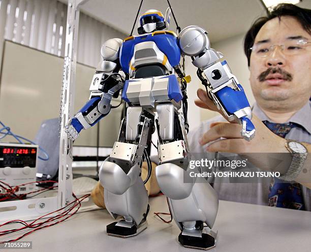 Robot engineer Jin Sato puts final check on the new humanoid robot "HRP-2m Choromet", which is a downsized model of a well known humanoid robot...