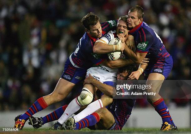 Michael Henderson of the Dragons is tackled during the round 12 NRL match between the Newcastle Knights and the St George Illawarra Dragons at Energy...