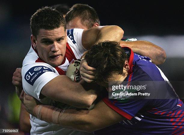 Corey Payne of the Dragons is tackled during the round 12 NRL match between the Newcastle Knights and the St George Illawarra Dragons at Energy...