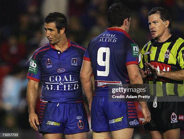 Andrew Johns of the Knights spits while talking to referee Tony Archer after a Dragons try during the round 12 NRL match between the Newcastle...