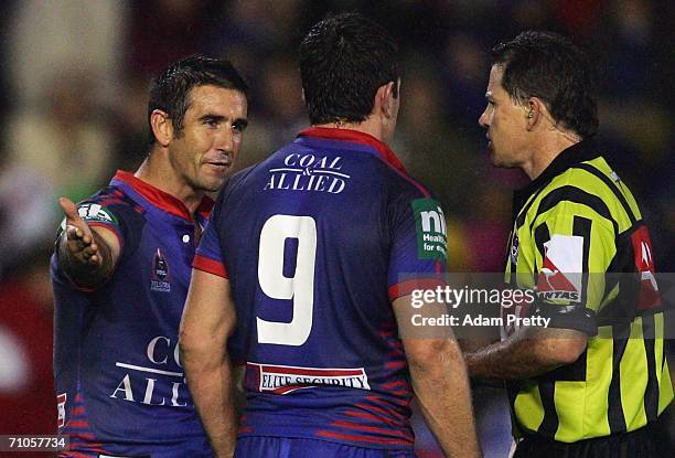 Andrew Johns and Danny Buderus of the Knights have words to referee Tony Archer after a Dragons try during the round 12 NRL match between the...