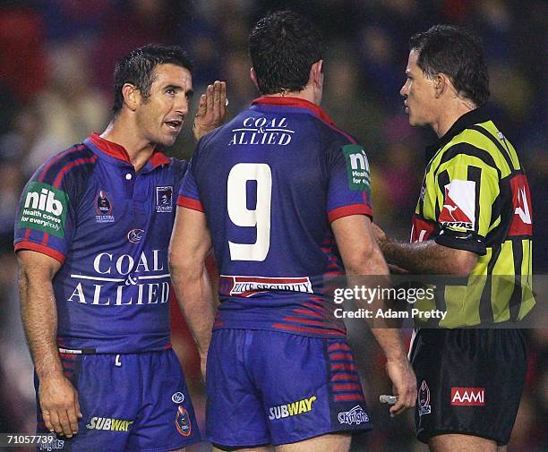 Andrew Johns and Danny Buderus of the Knights have words to referee Tony Archer after a Dragons try during the round 12 NRL match between the...