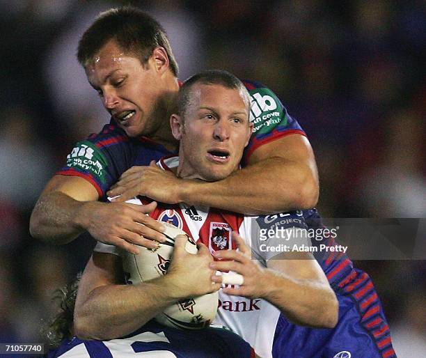 Ben Hornby of the Dragons is tackled during the round 12 NRL match between the Newcastle Knights and the St George Illawarra Dragons at Energy...
