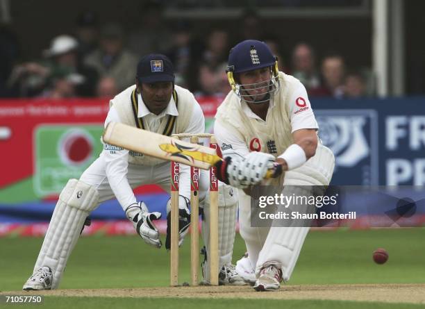 Kevin Pietersen of England plays a shot as Kumar Sangakkara the Sri Lankan wicket-keeper looks on during the second day of the npower second Test...