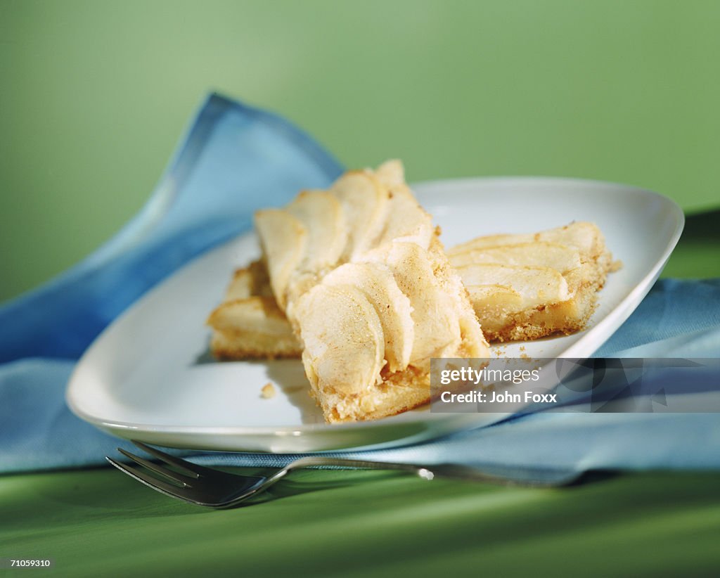 Slice of pudding on plate with fork, close-up