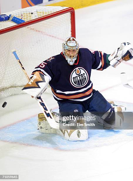 Goaltender Dwayne Roloson of the Edmonton Oilers protect the goal against the defense of the Mighty Ducks of Anaheim during game four of the Western...