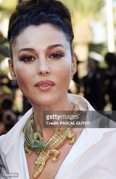 Member of the Jury Italian actress Monica Bellucci, wearing a Cartier necklace, poses upon arriving at the Festival Palace for the premiere of French...