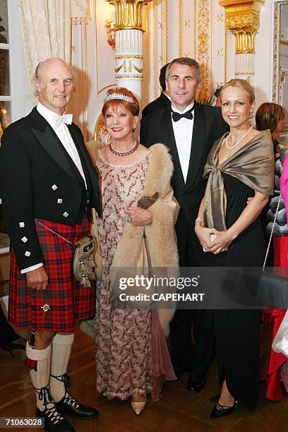 Walter and Cathleen Ross, hosts of Lithuanian Ambassador Vygaudas Usackas and his wife Loretta Usackas, arrive together at the International Red...