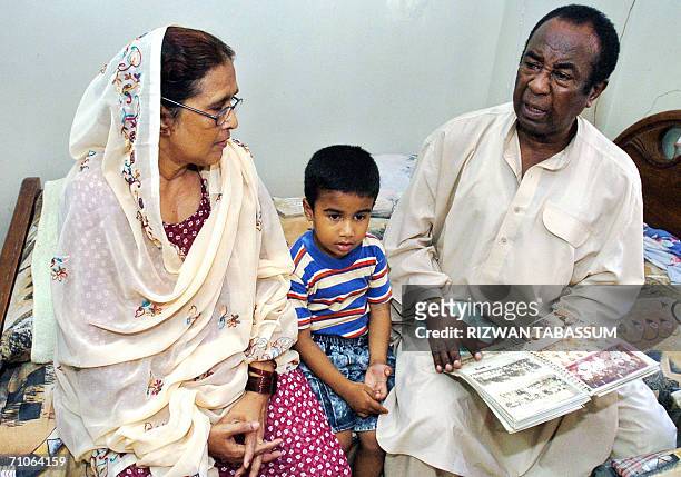 In this picture taken 25 May 2006, Shows Abdul Ghafoor sits with his wife Sabiha and grandson as he speaks during an interview with AFP at his...