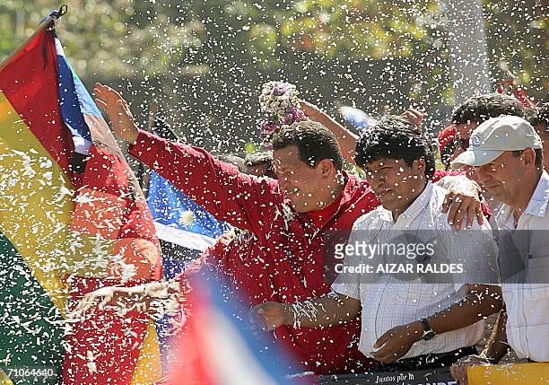 Venezuelan President Hugo Chavez, Bolivian President Evo Morales and Cuban State council's vice-president Carlos Lage wave to crowd upon their...