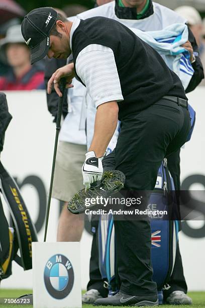 Paul Casey of England removes grass from his spikes during the Third Round of the BMW Championship at The Wentworth Club on May 27, 2006 in Virginia...