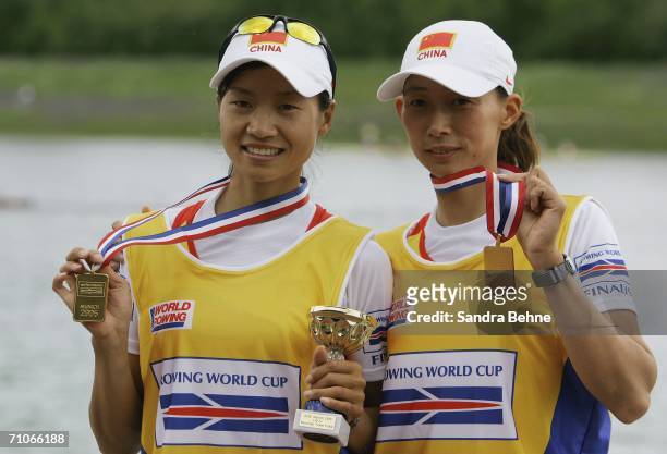 Hua Yu and Dongxiang Xu of China pose with their gold medals after their leightweight women's double sculls final during the Rowing World Cup at the...