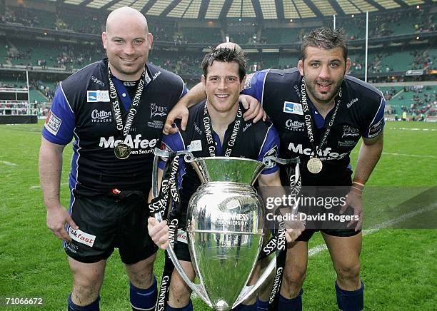 The Sale Front Row of Stuart Turner, Andy Titterrell and Lionel Faure pose with the trophy following their team's victory during the Guinness...