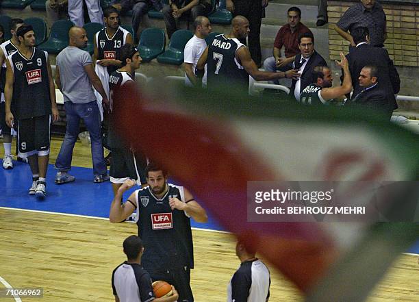 An Iranian flag flutters as Lebanon's Sagesse team players leave during the fourth leg of their basketball match against Iran's Saba Battery in the...