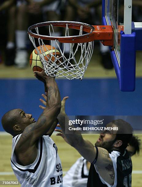 Lebanese Sagesse player Fadi Khatib tries to stop Iran's Saba Battery player, Andre Pitz, from scoring during the finals of the West Asian Clubs...