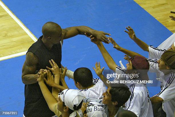 Player of Iran's Saba Battery, Andre Pitz, is greeted by Iranian fans after the basketball team's final West Asian Clubs Championship game against...