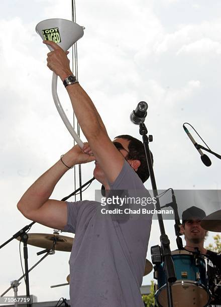 Stephan Jenkins of Third Eye Blind drinks from "beer bong" on stage at the 90th running of the Indianapolis 500 - Miller Lite Carb Day Concert Fe on...