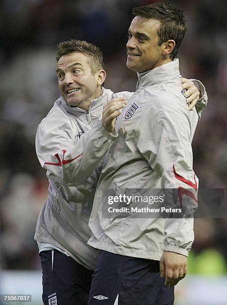 Robbie Williams and Bradley Walsh of England celebrate at the end of the Soccer Aid Unicef and ITV Football Match between England and the Rest of the...