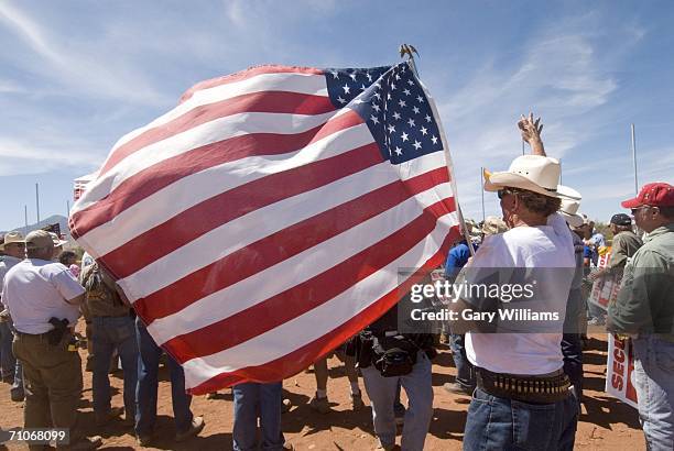 Volunteers of the Minuteman Civil Defense Corp. Were on hand with the American flags as they start to build a new fence on May 27, 2006 in Palominas,...