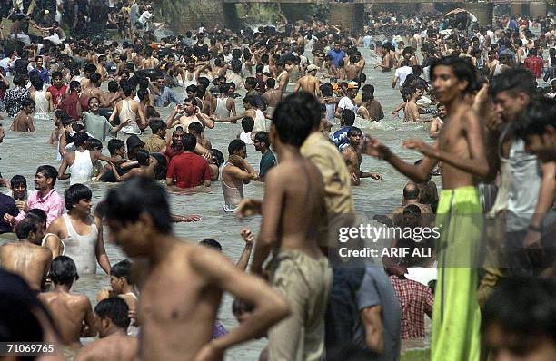 Pakistani youths enjoy the cool water as they bathe at a canal in Lahore, 28 May 2006. According to the Meteorological Department, the maximum...