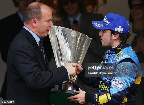 Fernando Alonso of Spain and Renault, receives his winners trophy from Prince Albert II of Monaco after victory in the Monaco Formula One Grand Prix...