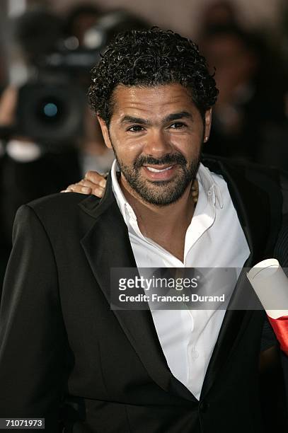 Actor Jamel Debbouze poses with the Best Performance By An Actor Award for Indigenes at the Palme d'Or Award Photocall during the closing ceremony at...