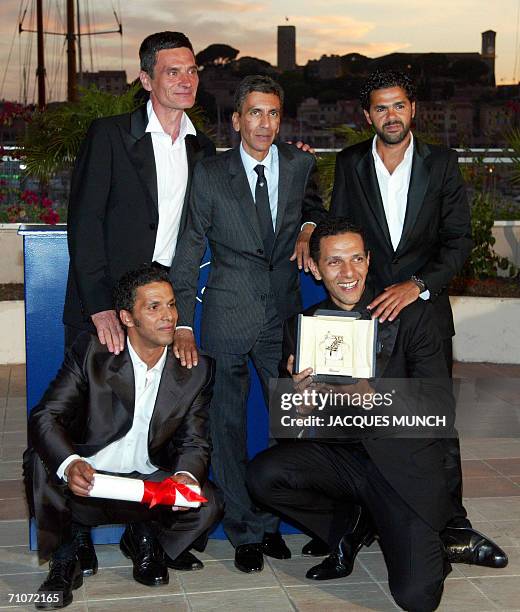 French actor Bernard Blancan, director Rachid Bouchareb and actor Jamel Debbouze pose with actors Sami Bouajila and Roschdy Zem during a photocall...