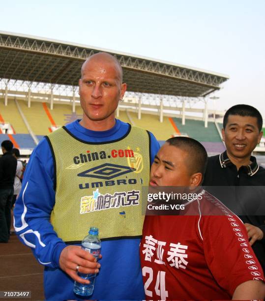 Carsten Jancker stands for a photo with a fan during a training session with Shanghai Shenhua on May 27, 2006 in Changchun, Jilin province, China.