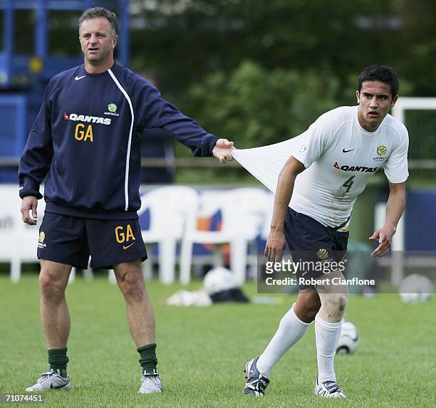 Tim Cahill of Australia with assistant coach Graham Arnold during a training session as Australia prepare for the 2006 World Cup, held at the Mierlo...