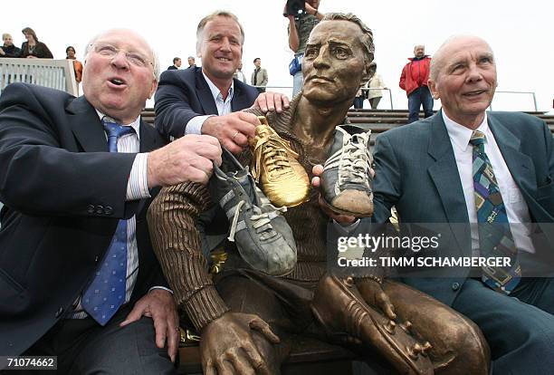 Herzogenaurach, GERMANY: Former German football stars Uwe Seeler, Horst Eckel and Andreas Brehme pose for photographers after the unveiling of a...