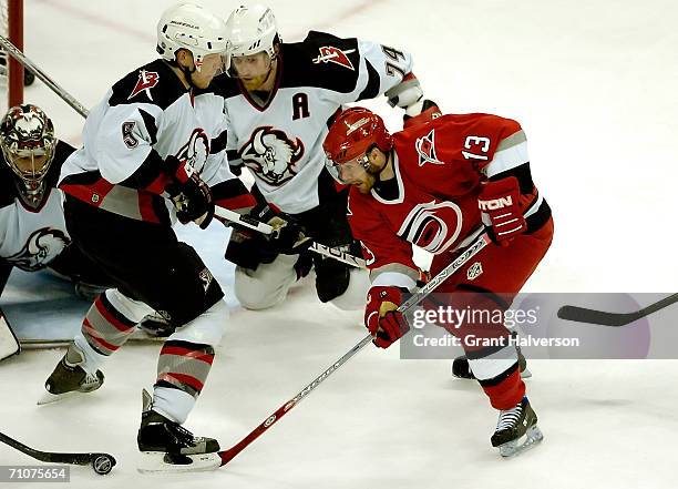 Ray Whitney of the Carolina Hurricanes tries to get past the Buffalo sabres defense in game five of the Eastern Conference Finals in the 2006 NHL...