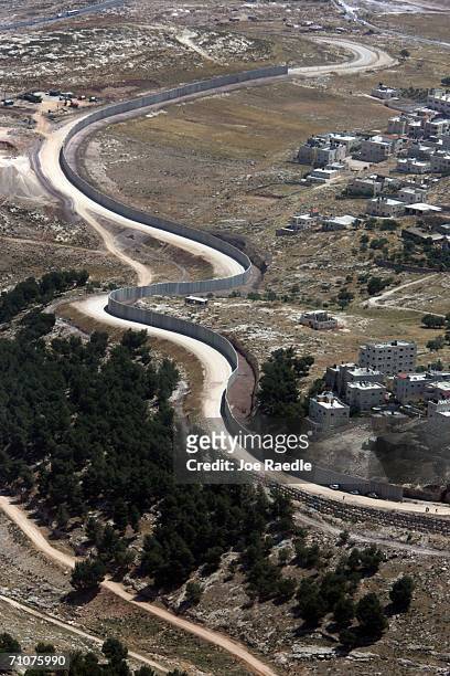 Israel's separation barrier is shown as it cuts a winding path between East Jerusalem and Palestinian homes May 29, 2006 near the the West Bank...
