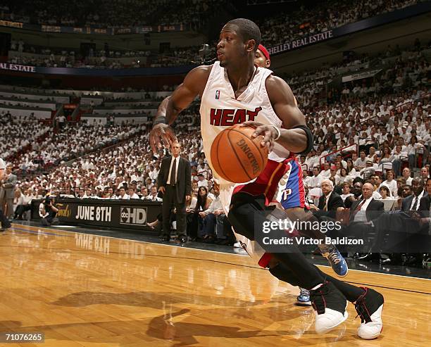 Dwyane Wade of the Miami Heat drives against Rasheed Wallace of the Detroit Pistons in game four of the Eastern Conference Finals during the 2006 NBA...