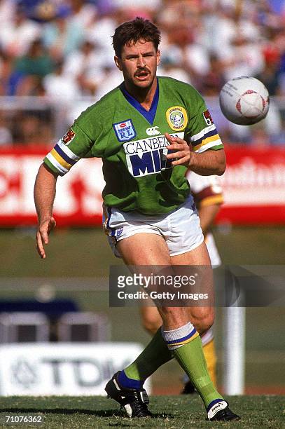 Gary Belcher of the Raiders offloads the ball during a NSWRL match between the Brisbane Broncos and the Canberra Raiders at Lang Park 1993, in...
