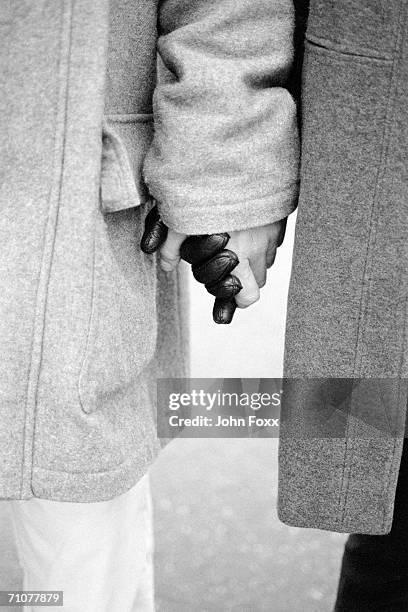 man and woman holding hands, mid section - black and white holding hands stock pictures, royalty-free photos & images