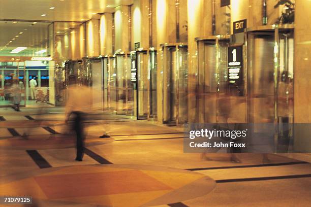 man in shopping mall - department store stock pictures, royalty-free photos & images