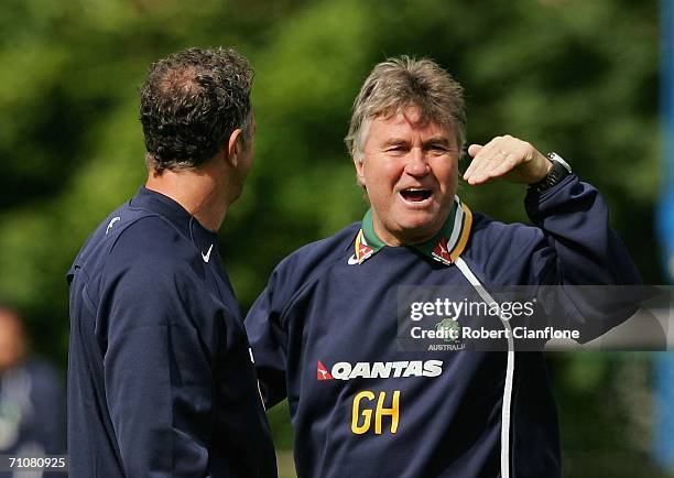 Australian coach Guus Hiddink talks to his assistant coach Graham Arnold during a training session as Australia prepare for the 2006 World Cup, held...