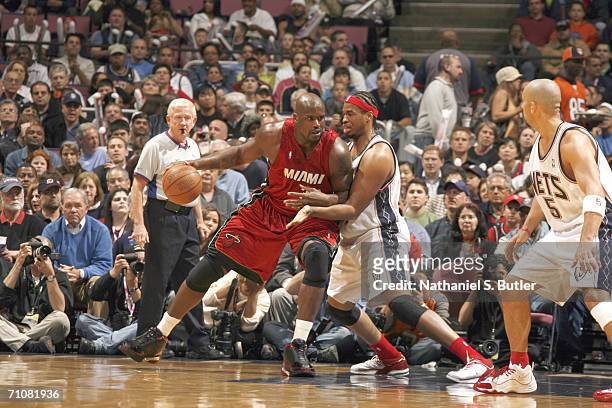 Shaquille O'Neal of the Miami Heat is defended by Jason Collins of the New Jersey Nets in game four of the Eastern Conference Semifinals during the...