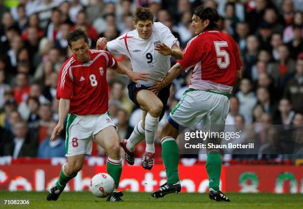 Steven Gerrard of England takes the ball between Hungary's Pal Dardai and Laszio Eger during the International Friendly match between England and...