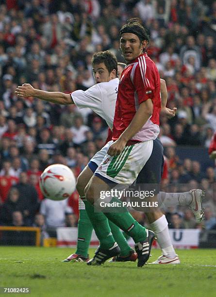 Manchester, UNITED KINGDOM: England's Joe Cole shoots wide past Hungary's Laszio Eger during their international friendly soccer match at Old...