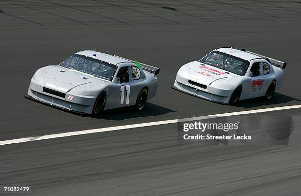 Denny Hamlin, driver of the FedEx Chevrolet, leads Brian Vickers, driver of the Hendrick Motorsports Chevrolet, during NASCAR Nextel Cup Series...