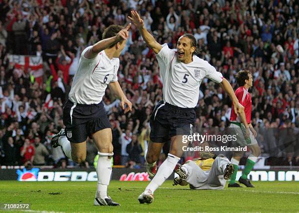 John Terry of England celebrates with teammate Rio Ferdinand after scoring his team's second goal during the International Friendly match between...