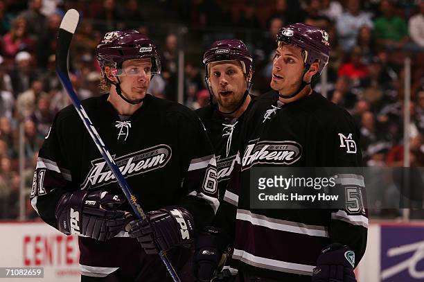Corey Perry, Travis Moen and Ryan Getzlaf of the Mighty Ducks of Anaheim look on during a break in game action against the Edmonton Oilers during...