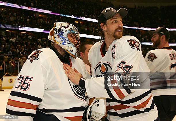 Ryan Smyth of the Edmonton Oilers congratulates teammate Dwayne Roloson of the Edmonton Oilers after they defeated the Mighty Ducks of Anaheim 2-1 in...