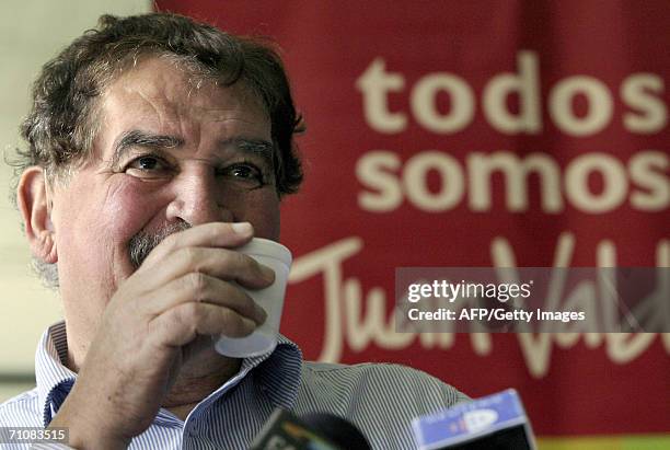 Carlos Sanchez, former "Juan Valdez" coffee grower icon, drinks a cup of coffee during a press conference 30 May, 2006 in Bogota. Sanchez, who for...