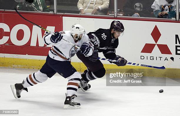 Sergei Samsonov of the Edmonton Oilers lines up Chris Kunitz of the Mighty Ducks of Anaheim for a check during game five of the NHL Western...