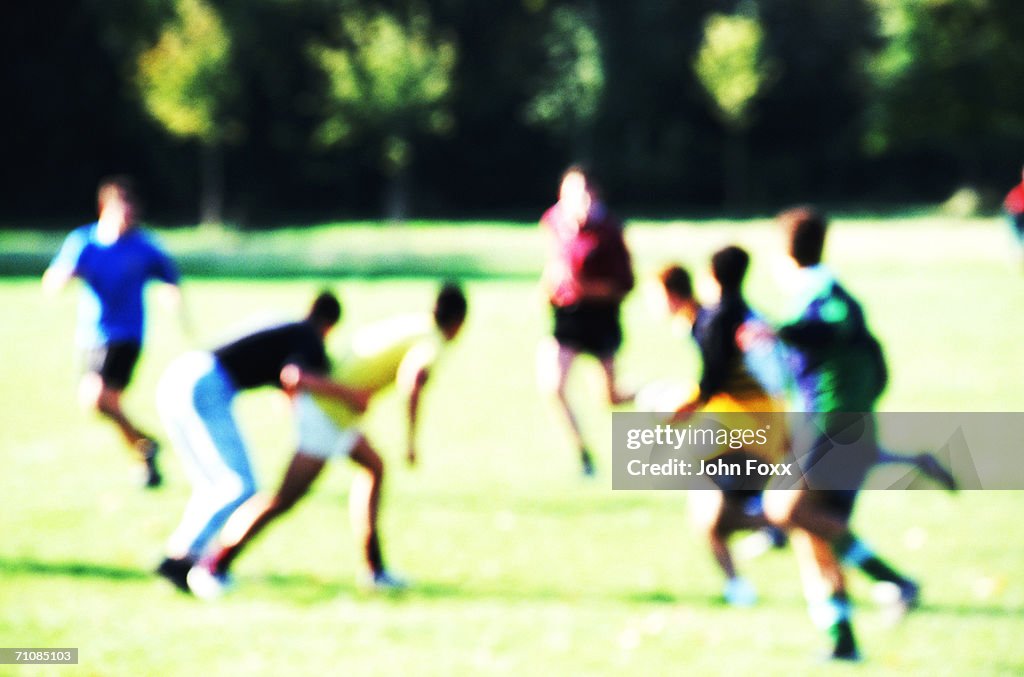 Men playing in park, defocused