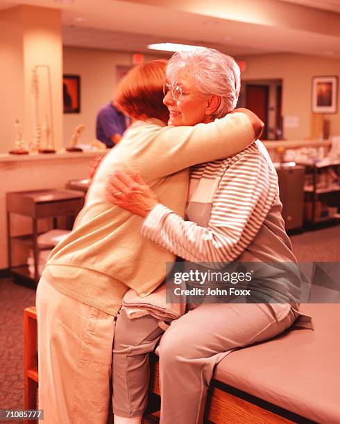 senior women embracing in hospital - 61811 stock pictures, royalty-free photos & images