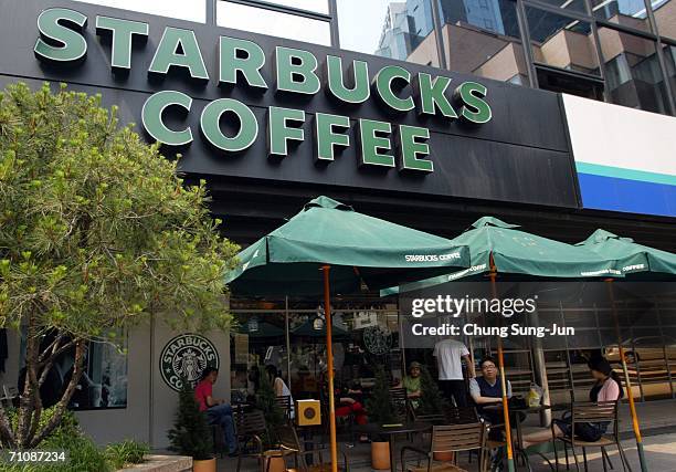 Customers sit outside a Starbucks coffee store on May 31, 2006 in Seoul, South Korea. The National Tax Service has launched its first Tax audit of...